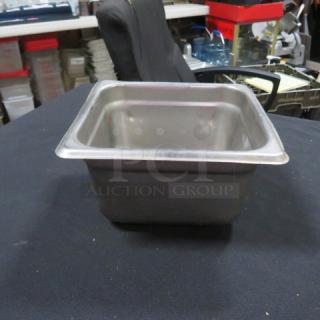 Stainless steel 1/6 size hotel pan, 4 inches deep, used condition. Ideal for commercial kitchen use.