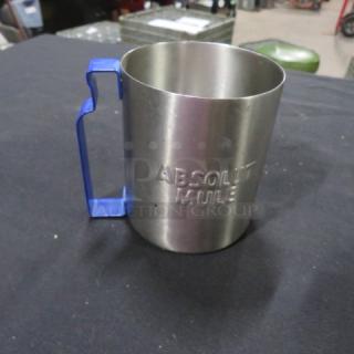 Stainless steel mug with "Absolute Mule" embossed, featuring a blue handle; appears in excellent condition.