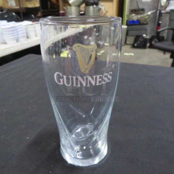 Guinness beer glass with logo, clear glass, gently used condition, smooth curved design. Item number: 17XBID.