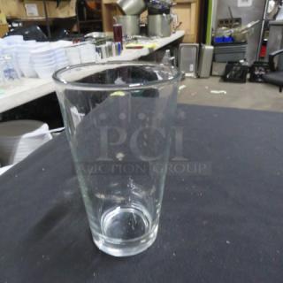 Clear beer glass, 10XBID model, in good condition, standard pint size. No visible markings or defects.