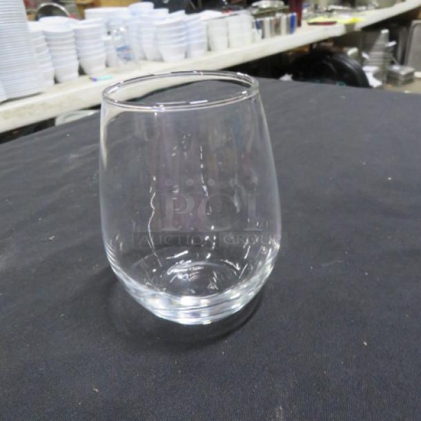 Clear stemless wine glass, gently used, transparent with a smooth finish. Ideal for casual or formal settings.