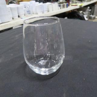 Clear stemless wine glass, gently used, transparent with a smooth finish. Ideal for casual or formal settings.