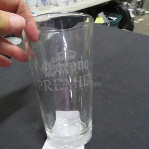 Corona Premier beer glass with etched logo, clear glass, excellent condition. Suitable for collectors or beer enthusiasts.