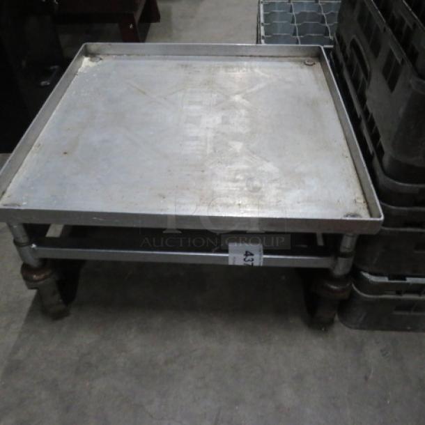 Metal dish rack dolly with wheels, used, sturdy build, signs of wear, ID tag marked "43" visible on frame.