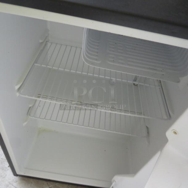 Haier refrigerator, model HC27SF10RB, 18x18x26 inches, interior view with shelves. Door needs adjustment.