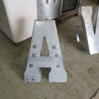 Aluminum letter "A" with rivet details, some weathering, and a sticker. Ideal for decor or signage.