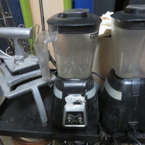 Waring BB300 commercial blender, 120V, with visible wear, black base, clear container, dual-speed control.