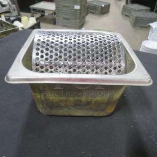 Stainless steel butter roller with perforated design, used condition with visible wear.