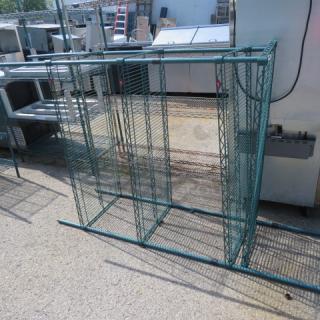 Green Metro shelf unit with four shelves, partially assembled. Dimensions: 48x21x75 inches. Steel construction, outdoor setting.