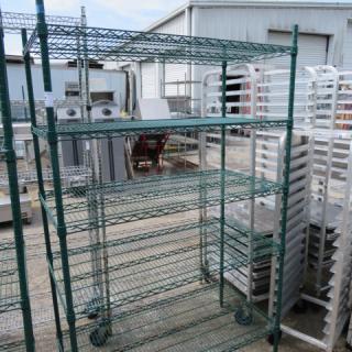 Metro green coated metal shelf, 5-tier, 48x24x74 inches, on wheels. Used condition with visible outdoor setting.