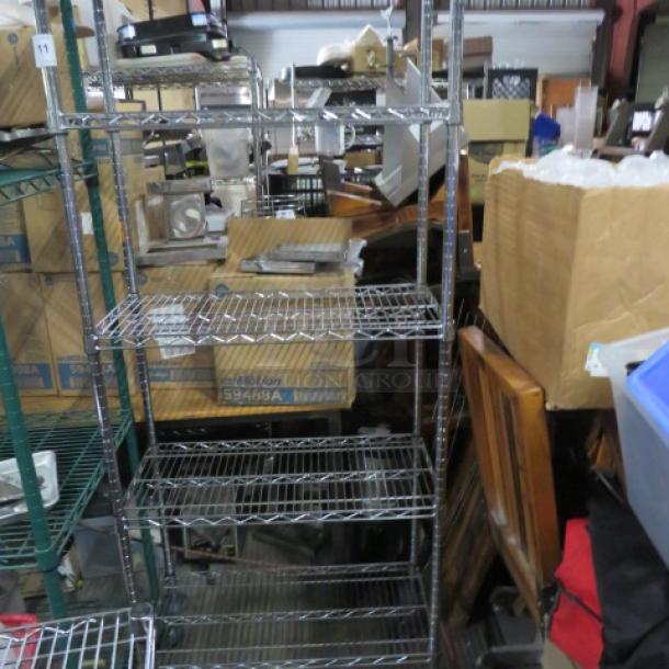 Metro metal shelf unit with five wire shelves on casters, 30x14x80 inches. Used condition, ideal for storage or organization.