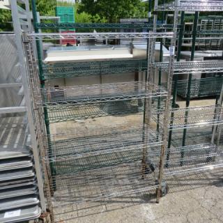 Metro metal shelf unit with four wire shelves on casters, measuring 36x14x54 inches. Ideal for storage and easy mobility.
