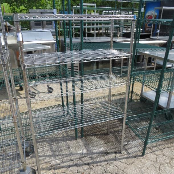 Metro metal shelf unit with four wire shelves and casters, measuring 36x14x54 inches. Used condition.