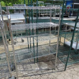 Metro metal shelf unit with four wire shelves and casters, measuring 36x14x54 inches. Used condition.