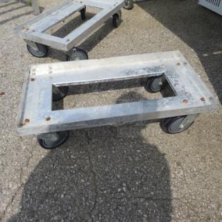 Aluminum dolly with 27x14x8 dimensions, four wheels, sturdy frame, light wear, ideal for heavy-duty transport.