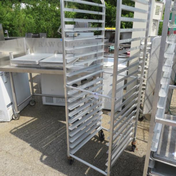 Stainless steel speed rack on casters, dimensions 20.5x26x69 inches, used condition, multiple shelves, ideal for bakery use.