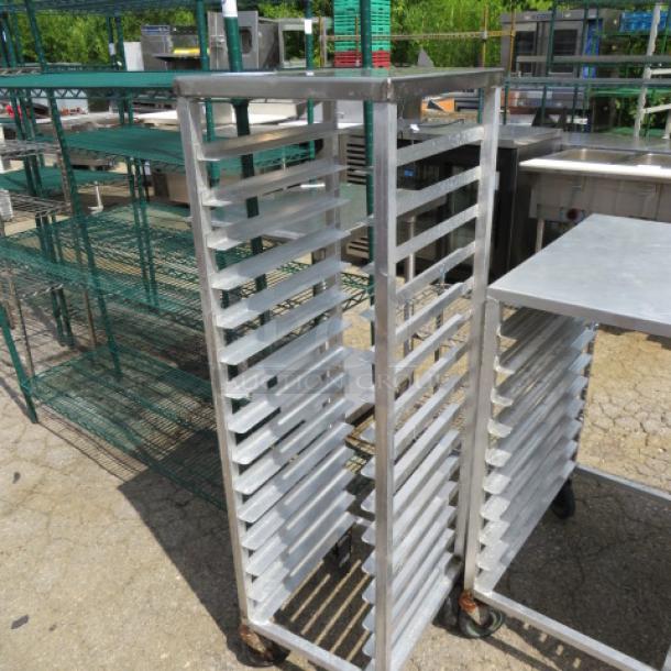 Aluminum speed rack on casters, 15.5x8x54 inches. Features multiple shelves for bakery use. Slight wear visible.