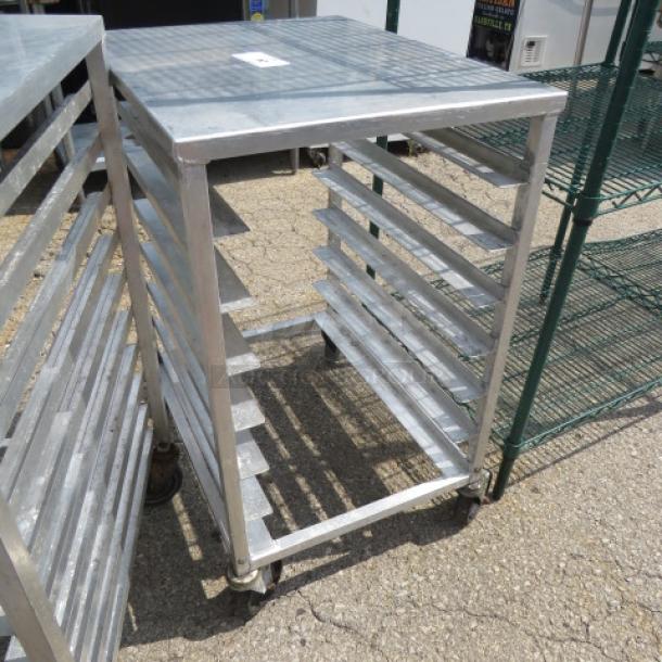 Metal speed rack on casters, dimensions 20.5x26x36 inches, used condition, multiple shelves for storage, sturdy frame.