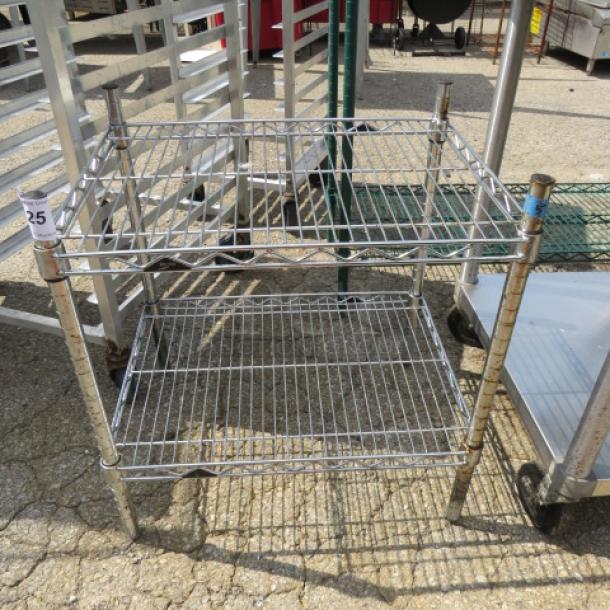 Metal Metro shelf unit with two adjustable wire shelves, measuring 24x18x25 inches; shows light wear.