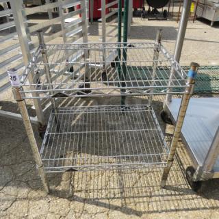 Metal Metro shelf unit with two adjustable wire shelves, measuring 24x18x25 inches; shows light wear.
