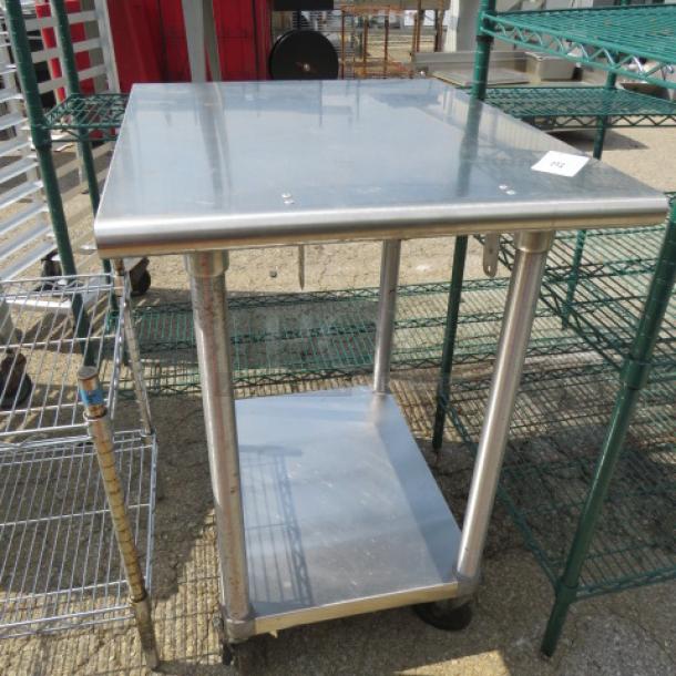 Stainless steel table with undershelf, 24x30x55 inches, on caster wheels. Durable, versatile kitchen or utility use.