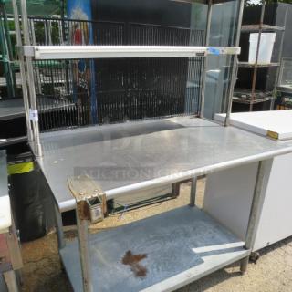 Stainless steel table with under shelf, two over shelves, 36" San Jamar ticket rail, can opener bracket, 48x31x66.5 inches.