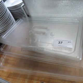 Clear full-size food storage lid, model 4XBID, in good condition. Label indicates quantity 37, auction company details visible.