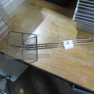 Metal mesh scoop with long handle, used condition, labeled "41," suitable for straining or frying tasks.