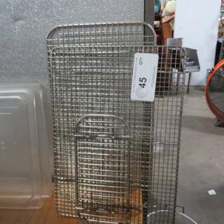 Assorted stainless steel cooling racks, various sizes, used condition, with a numbered auction tag reading "45" for identification.