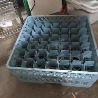 Blue plastic dishwasher rack with multiple compartments, used for holding dishes. Appears in good condition. Model 2XBID.