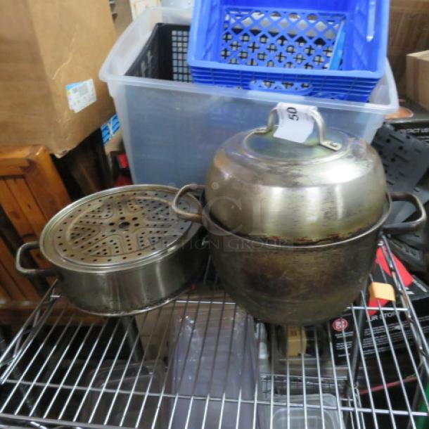 Metal cookware with lid and steamer, visibly worn. Includes storage bins in the background, with auction lot tag "50".