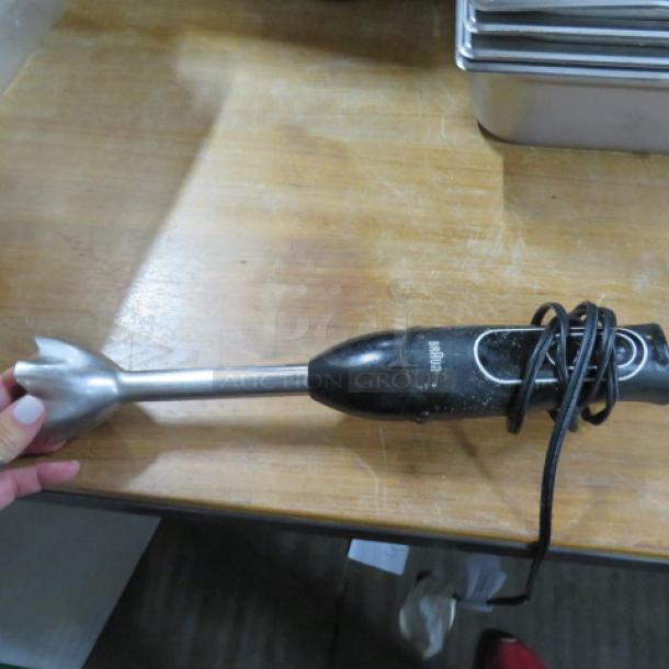 Braun stick blender, black handle, metal shaft, used condition, visible Braun logo, power cord wrapped around.