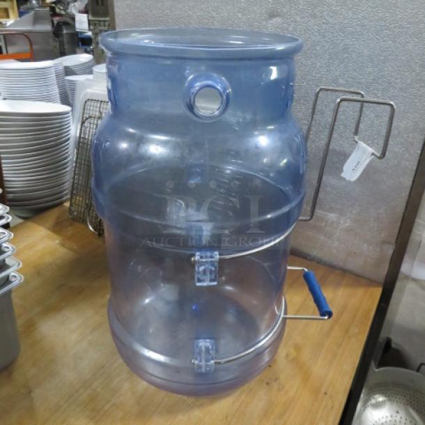 Translucent blue plastic ice bucket with round shape, carrying handle, and attached metal hinge. Good condition.