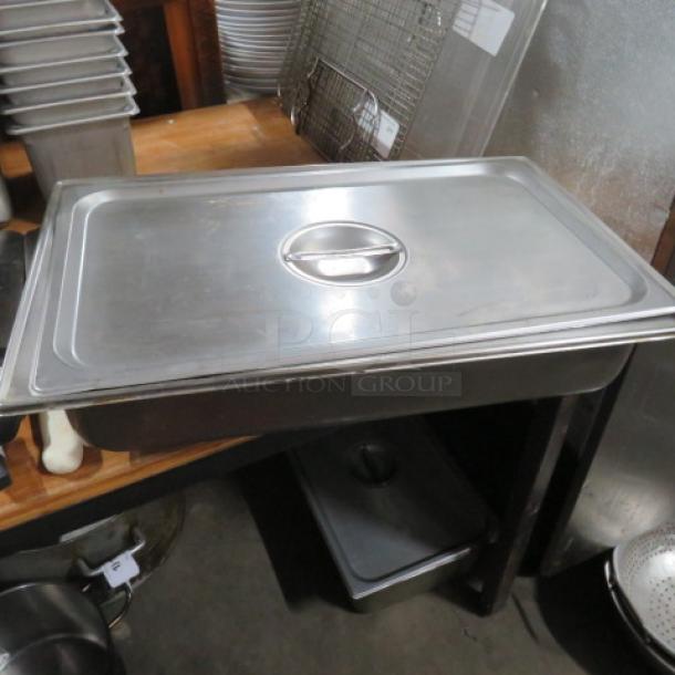 Full-size 4-inch deep stainless steel hotel pan with lid, shown in good condition. Ideal for catering use.