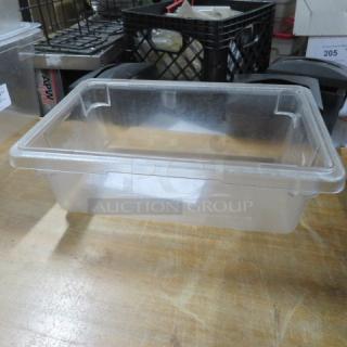 Clear 3-gallon food storage container, rectangular shape, transparent plastic, used condition, visible scratches. Tag: "2XBID."