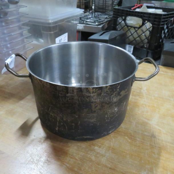 Vigor 12Qt stainless steel stock pot, model POT12. Features sturdy handles, shows surface wear. Ideal for large volume cooking.