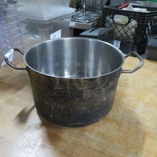 Vigor 12Qt stainless steel stock pot, model POT12. Features sturdy handles, shows surface wear. Ideal for large volume cooking.