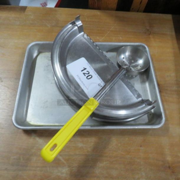 Lot of miscellaneous metal kitchenware including a tray, strainer, and utensils. Visible auction tag labeled "120".
