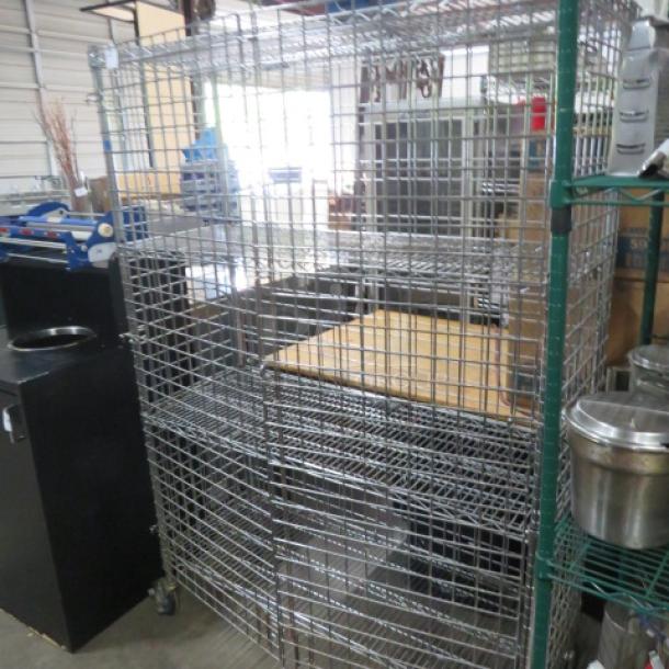 Metro liquor cage with 3 shelves, on casters, 48x18x70 inches, metal construction, good condition.