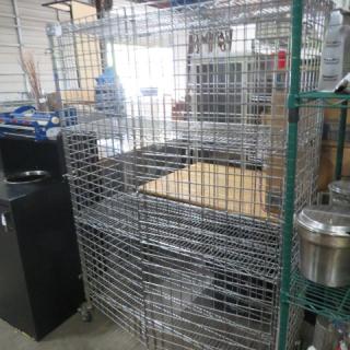 Metro liquor cage with 3 shelves, on casters, 48x18x70 inches, metal construction, good condition.