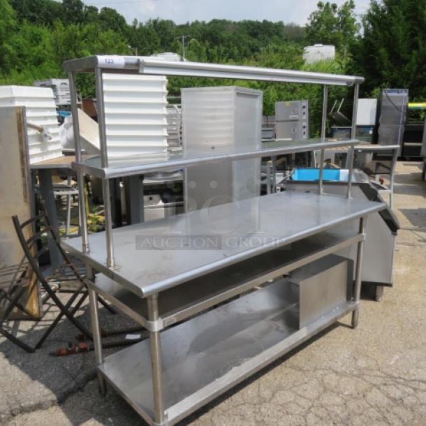 Advance Tabco stainless steel table, 72x30x67, with 2 lower shelves, 2 upper shelves, and a 60-inch San Jamar ticket rail.