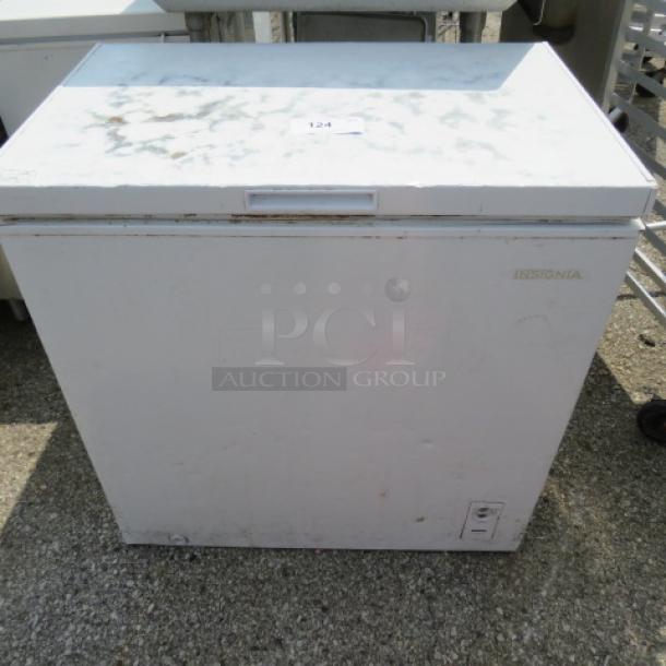 Insignia chest freezer, model NS-CZ70WHO, dimensions 32x22x33 inches. Visible wear on surface. Item #124 tag attached.