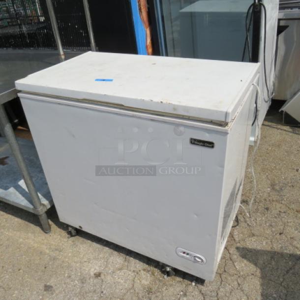 Magic Chef chest freezer, model HMCF7W4, in used condition, 35.5x21x35 inches, visible wear on exterior.