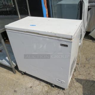 Magic Chef chest freezer, model HMCF7W4, in used condition, 35.5x21x35 inches, visible wear on exterior.
