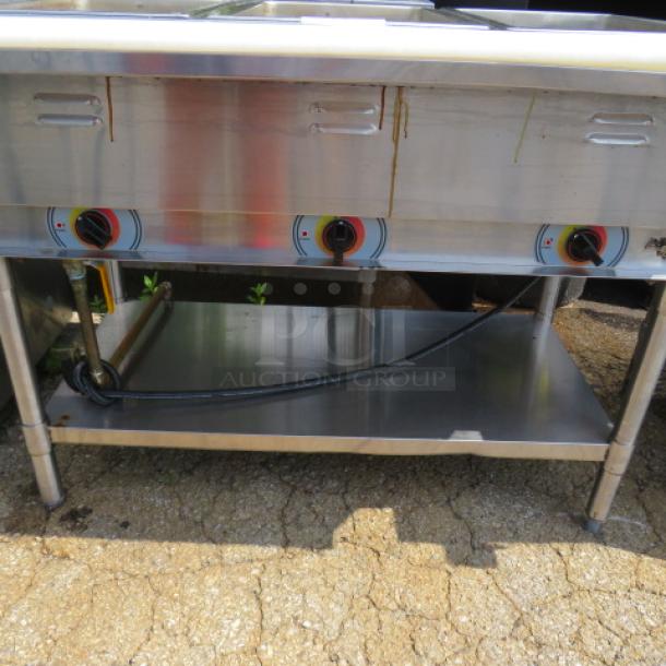 APW Wyott 3-well steam table with stainless steel undershelf and cutting board, dimensions 46x30x34.5 inches, in good condition.