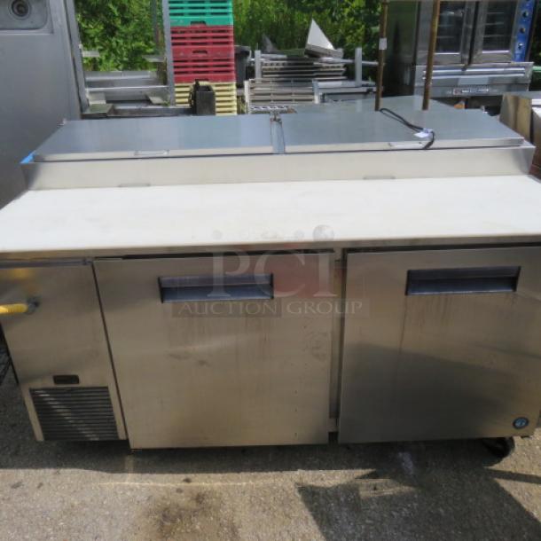 Hoshizaki PR67A refrigerated prep table with two doors, four racks, cutting board, and casters, 67x35x44 inches, 115V.