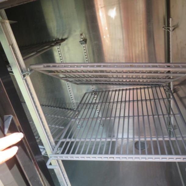 True 2-door back bar cooler, Model TBR48. Includes 2 racks, dimensions 48x25x37 inches, 115 volt, excellent condition.