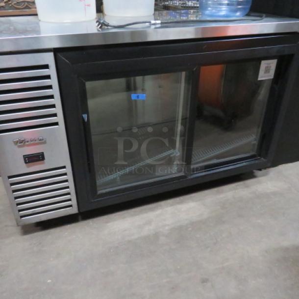 True 2 Door Back Bar Cooler, Model TBR48, with 4 racks, 48x25x37 inches, 115V, stainless steel finish, excellent condition.