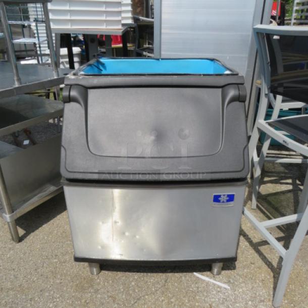 Manitowic ice bin, stainless steel, 30x34x38 inches, with top lid, used condition, suitable for commercial use.