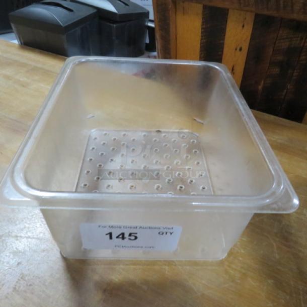 Perforated 1/2 size food storage container, 6-inch deep, transparent, with auction label "145" visible, in good condition.